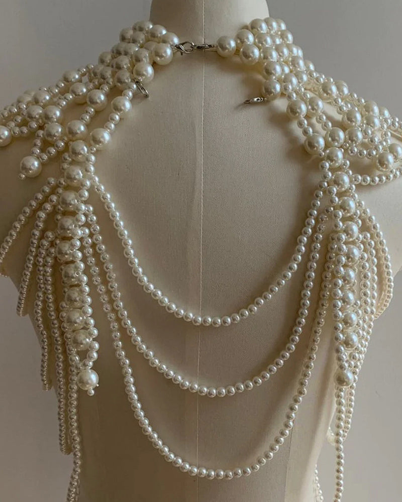 Pearl fringe halter top with layered pearl body chain, pearl strands and clasp at collar