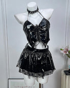 Black patent leather lingerie set: halter crop top, mini skirt, and choker on mannequin