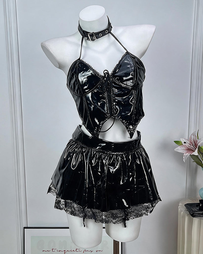 Black patent leather lingerie set: halter crop top, mini skirt, and choker on mannequin