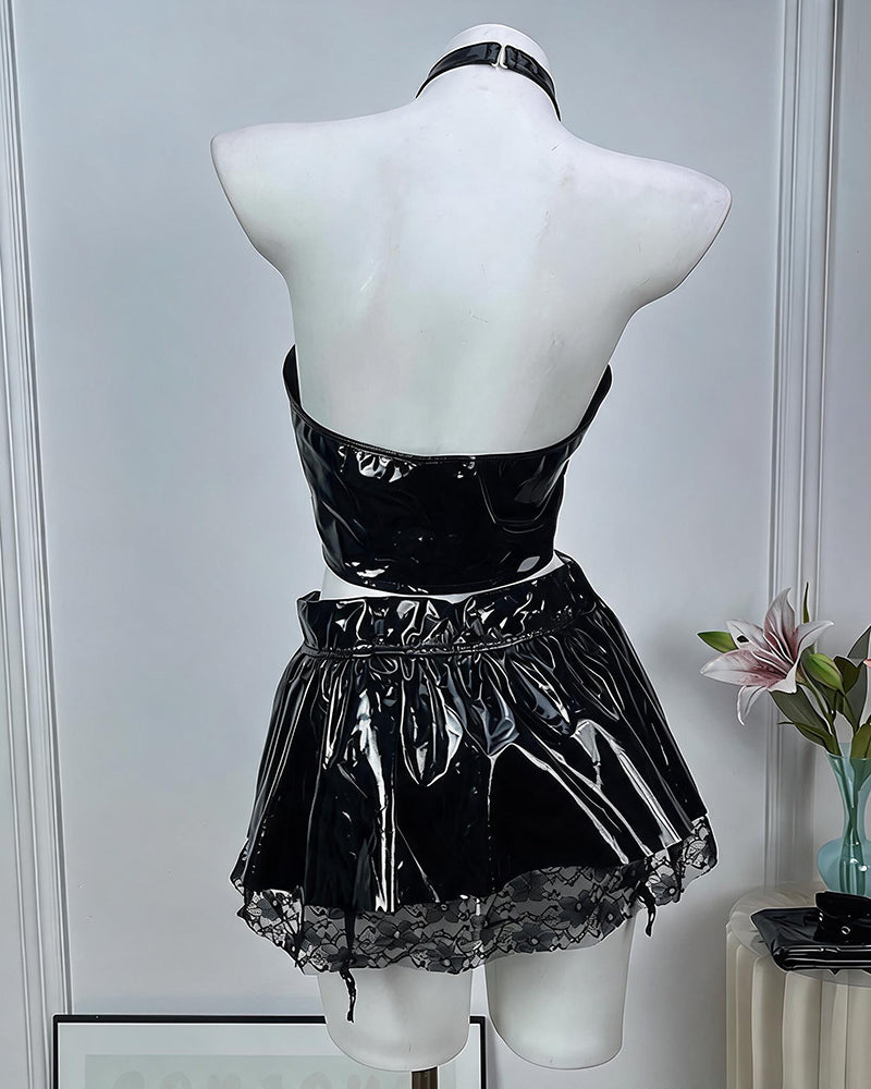 Back view of black patent halter crop top and mini skirt with choker on mannequin