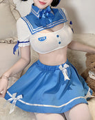 Sailor-style lingerie set close-up: white top, blue pleated skirt with bow trim, headband