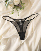 Black sheer mesh thong with double straps, low-rise lace-front coverage.