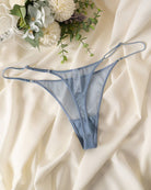 Blue sheer mesh thong with double straps, low-rise lace-front coverage.