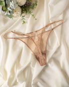 Skin-tone sheer mesh thong with double straps, low-rise lace-front coverage.