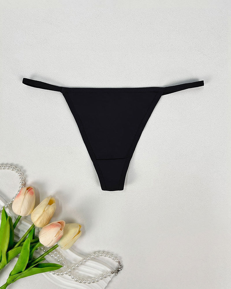 Low-rise thong panties in black with smooth seamless design and soft coverage.