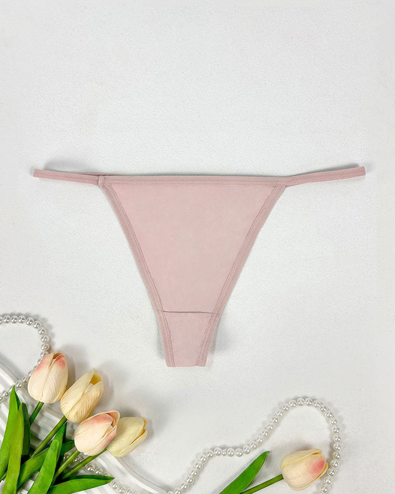 Low-rise thong panties in blush pink with seamless soft stretch fabric.