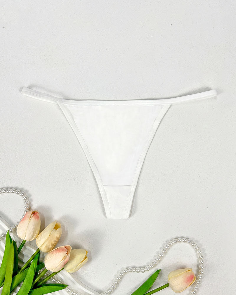 Low-rise thong panties in white with smooth seamless design and soft coverage.