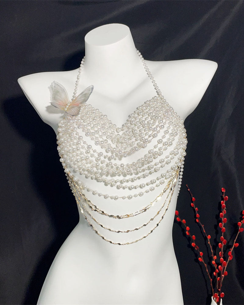 White pearl halter top on mannequin with butterfly applique and layered bead drape, gold chains