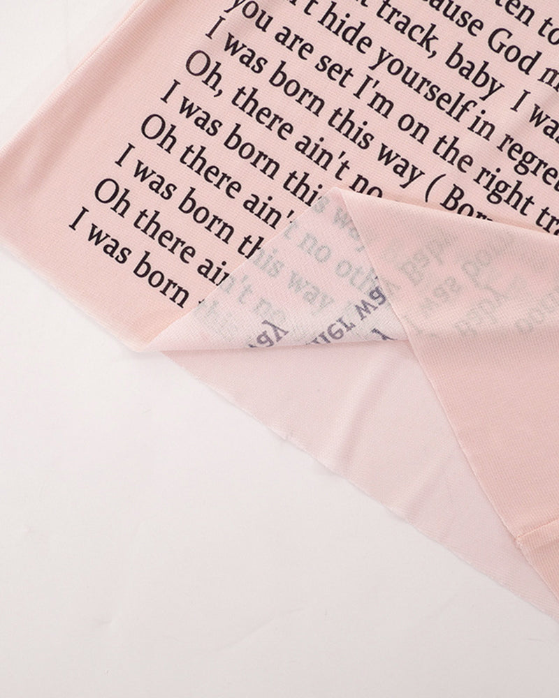 Pink-beige sheer mesh fabric with black lyric text print