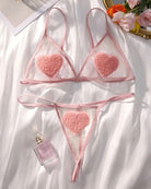 Pink sheer heart bra and thong set, lace pieces with heart appliques flat lay