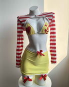 Mannequin front: yellow mini skirt lingerie set with striped sleeves and fishnet stockings.