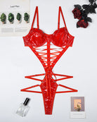 Red PVC patent lace-up corset bodysuit laid flat with underwire cups and lacing