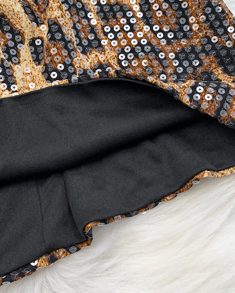 Leopard sequin bodice with black lining and tan leopard pattern, curved hem view