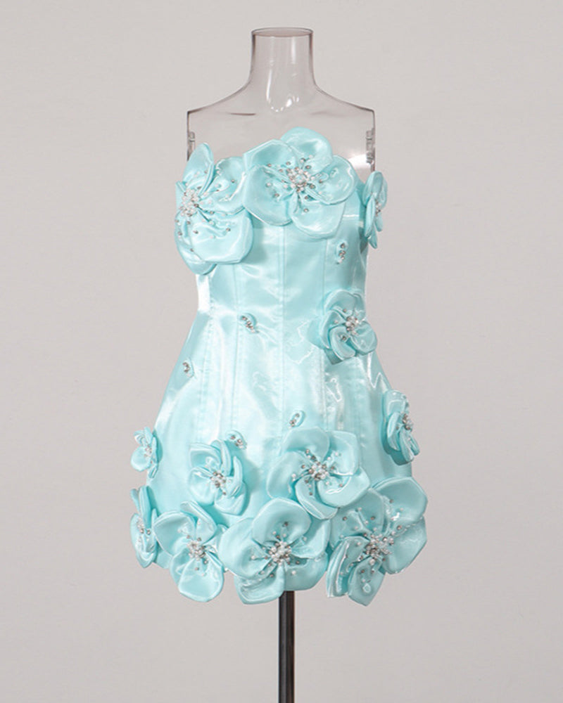 Sky blue strapless corset mini dress on a mannequin with 3D floral appliques and beads.