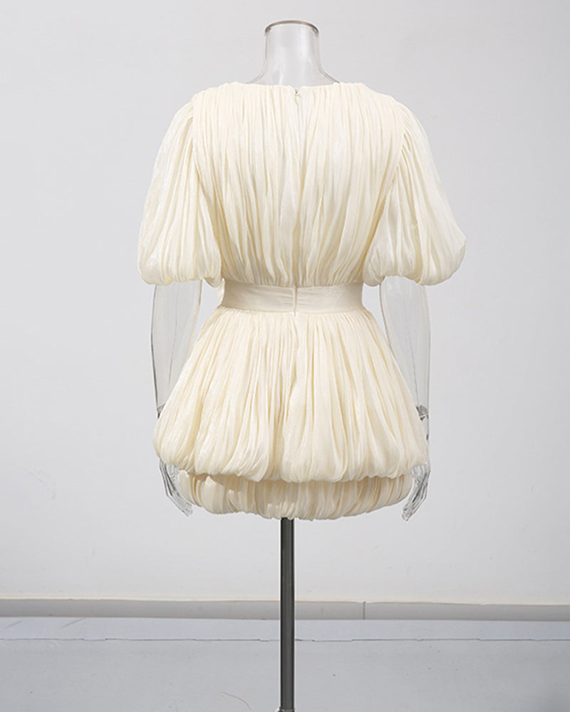 Champagne mini dress on mannequin with pleated puff sleeves and gathered waist