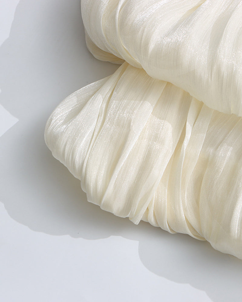 Champagne pleated fabric detail on puff sleeves with gathered texture