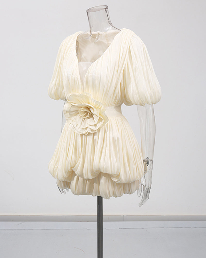 Champagne mini dress on mannequin with deep V, pleated puff sleeves, floral waist detail