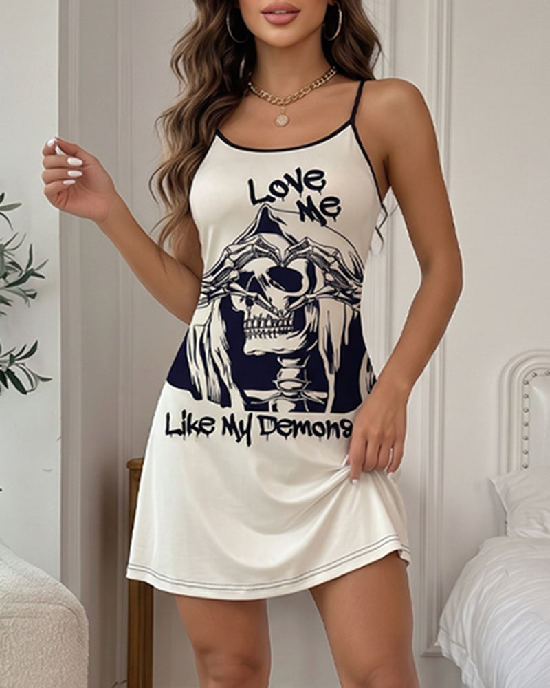 Cream mini slip dress with spaghetti straps and skull graphic, scoop neckline