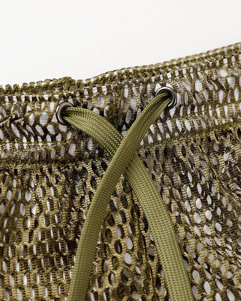 Army green open mesh shorts close-up with drawstring and metal eyelets.