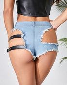 Light blue low-rise cut-off denim shorts with open-back distressing and black thigh straps
