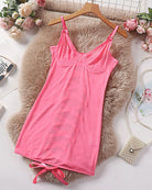 Pink sheer mesh underwire mini dress laid flat with tie hem and spaghetti straps