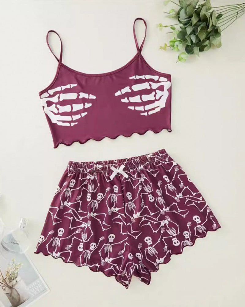 Purple skeleton-print cami crop top and matching pajama shorts set, flat lay