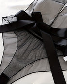 Black sheer mesh bodysuit detail: satin bow and wide ribbon ties