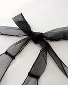 Black satin bow ribbon detail on sheer mesh halter bodysuit