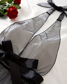 Black sheer mesh halter bodysuit with satin bow and long ribbon ties, flat lay