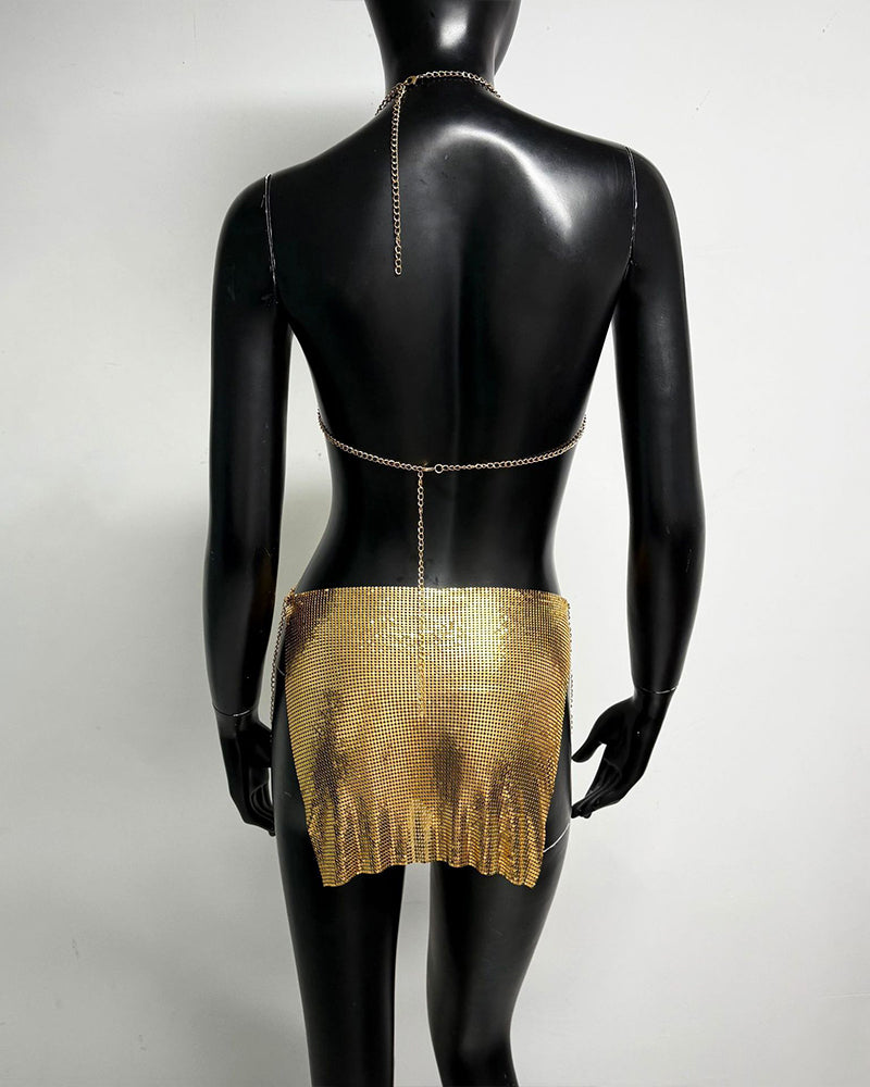 Gold metallic chain bra top and mini skirt set on mannequin, open back with chains