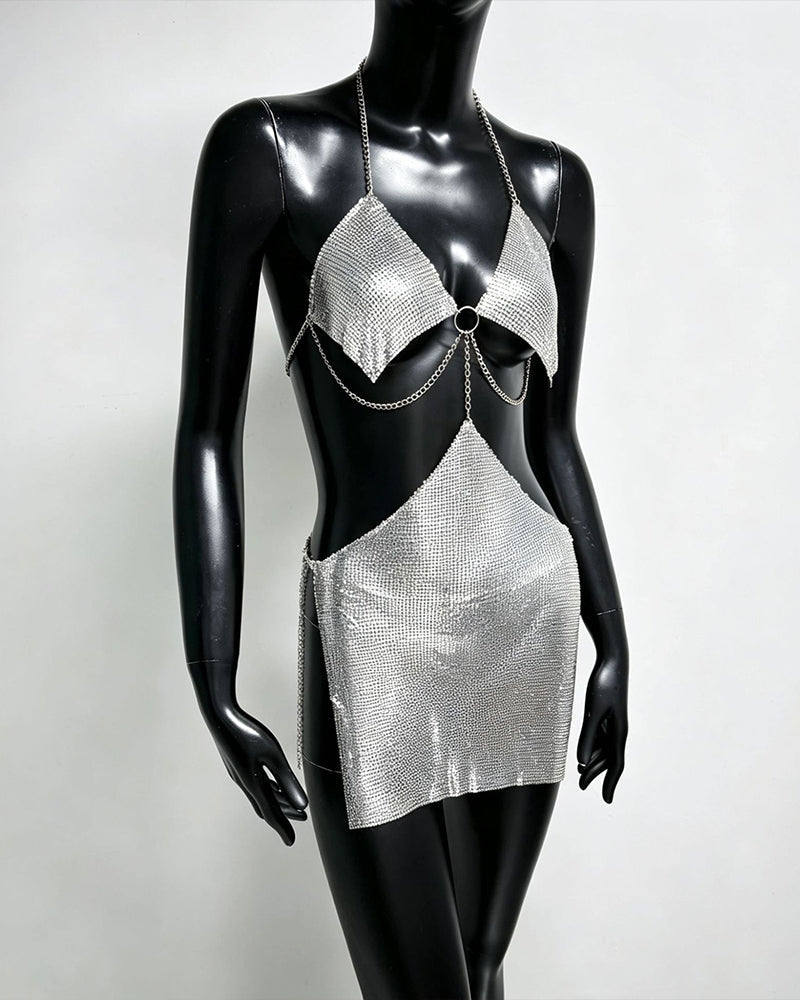 Silver metallic chain bra top and mini skirt set on mannequin with ring centerpiece