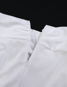 White wide-leg pants close-up of elastic waist and gathered front seam