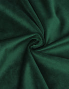 Green velvet fabric close-up with soft sheen and gathered fold detail
