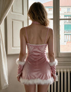 Pink corset mini dress with crisscross back straps and white fur trim, fur cuffs