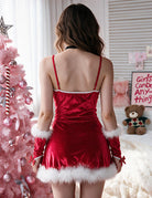 Red velvet mini dress with crisscross back straps, white fur hem, fur cuffs