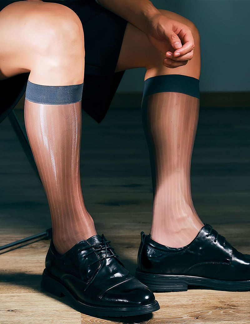 Sheer mid-calf dress socks with dark blue band at top, shown with hand adjusting