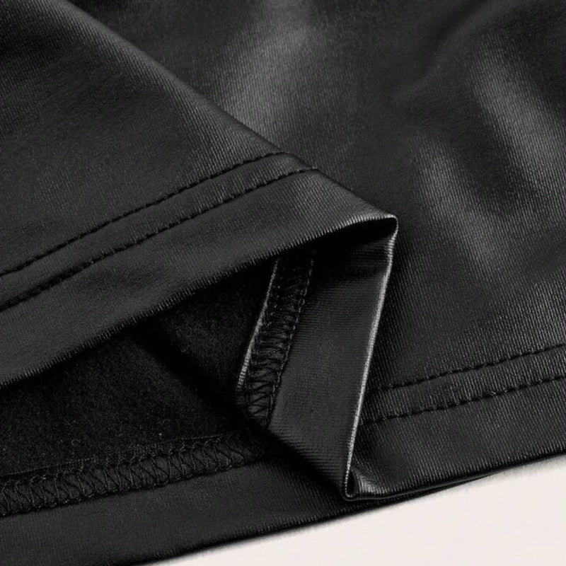 Black metallic crop top close-up of ruched seam and stitched hem edge.