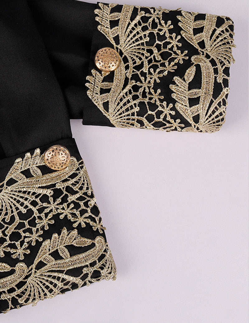 Baroque prince coat sleeve and cuff with ornate gold embroidery on dark fabric