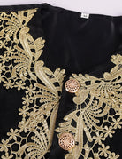 Baroque prince coat front with detailed gold filigree embroidery on dark fabric