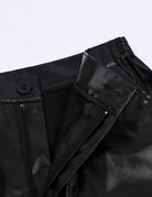 Black leather-look pants with zip fly, belt loops, and stitched seam details