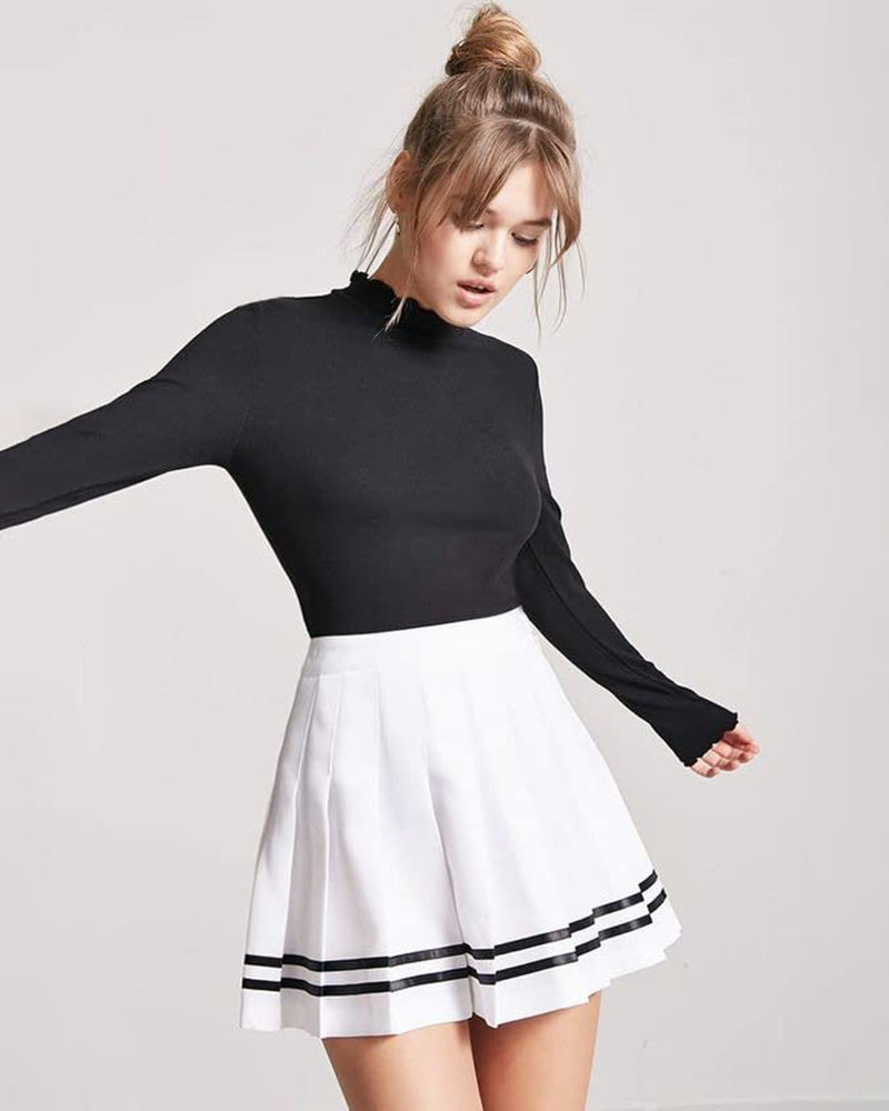 White pleated mini skirt with black stripes, school uniform style, paired with a black top.