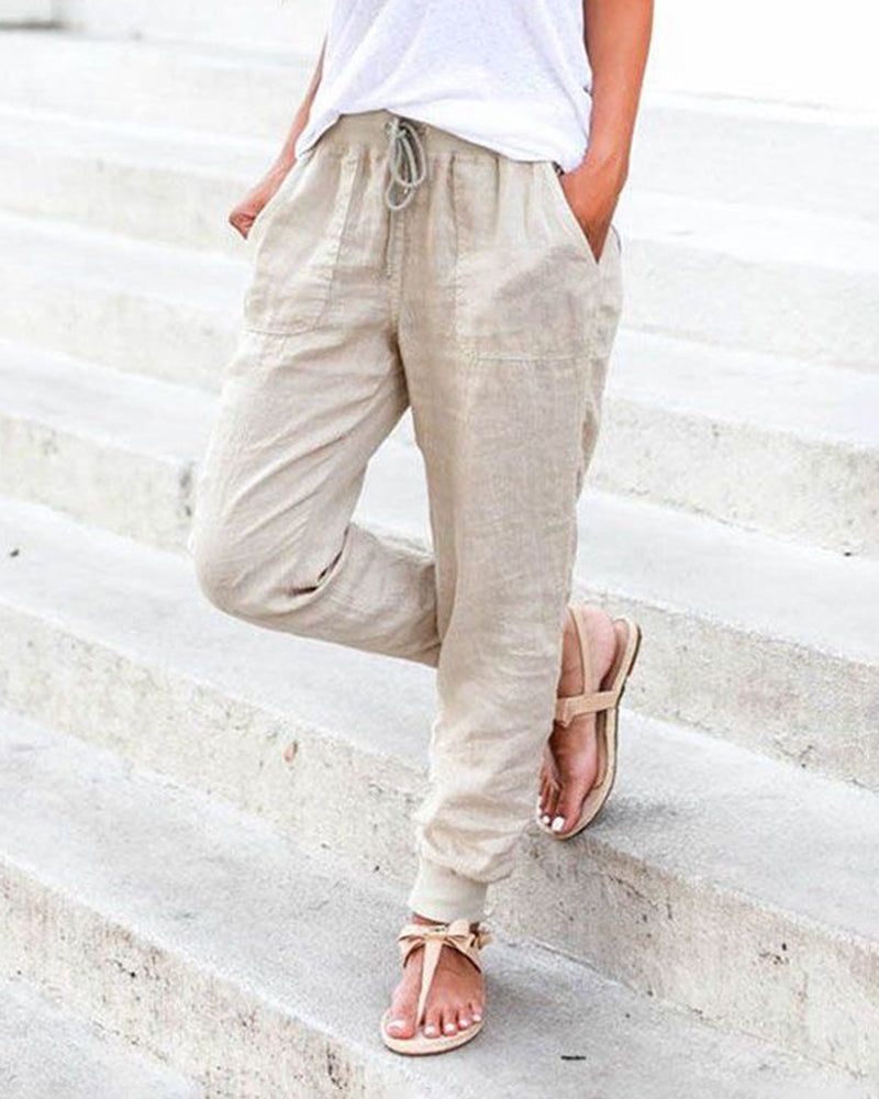 Beige drawstring jogger pants with pockets, casual style, perfect for leisure and daily wear.