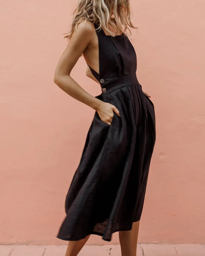 Black strap button waist pleated dress for vacation, featuring halter neckline and pleated skirt